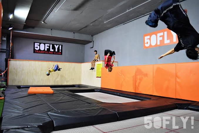 Kids jumping into a padded trampoline pit at 50FLY! Chiang Mai